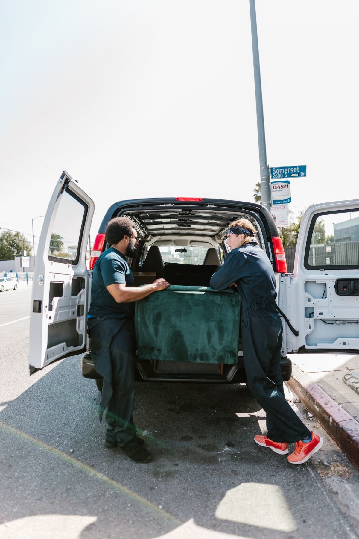 Dubai rubbish collection crew loading bulky household waste into a truck