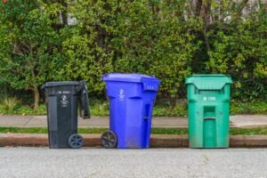 Colourful recycling bins lined up on a street representing Dubai waste collection in 2026