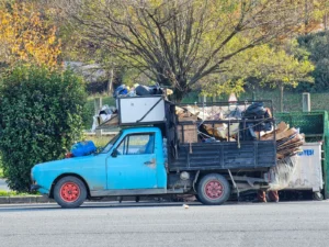 Loaded junk removal truck carrying household waste and old furniture for recycling in Dubai