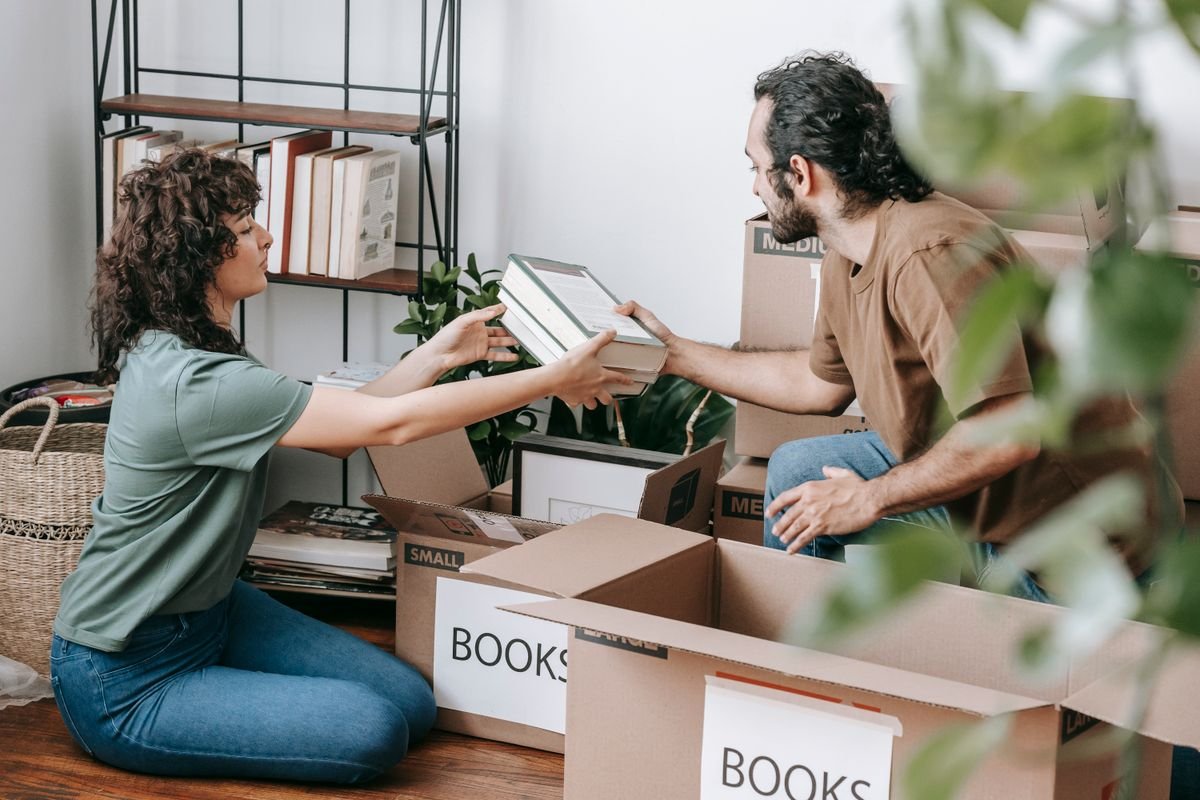 Couple packing boxes preparing to book junk removal in Dubai