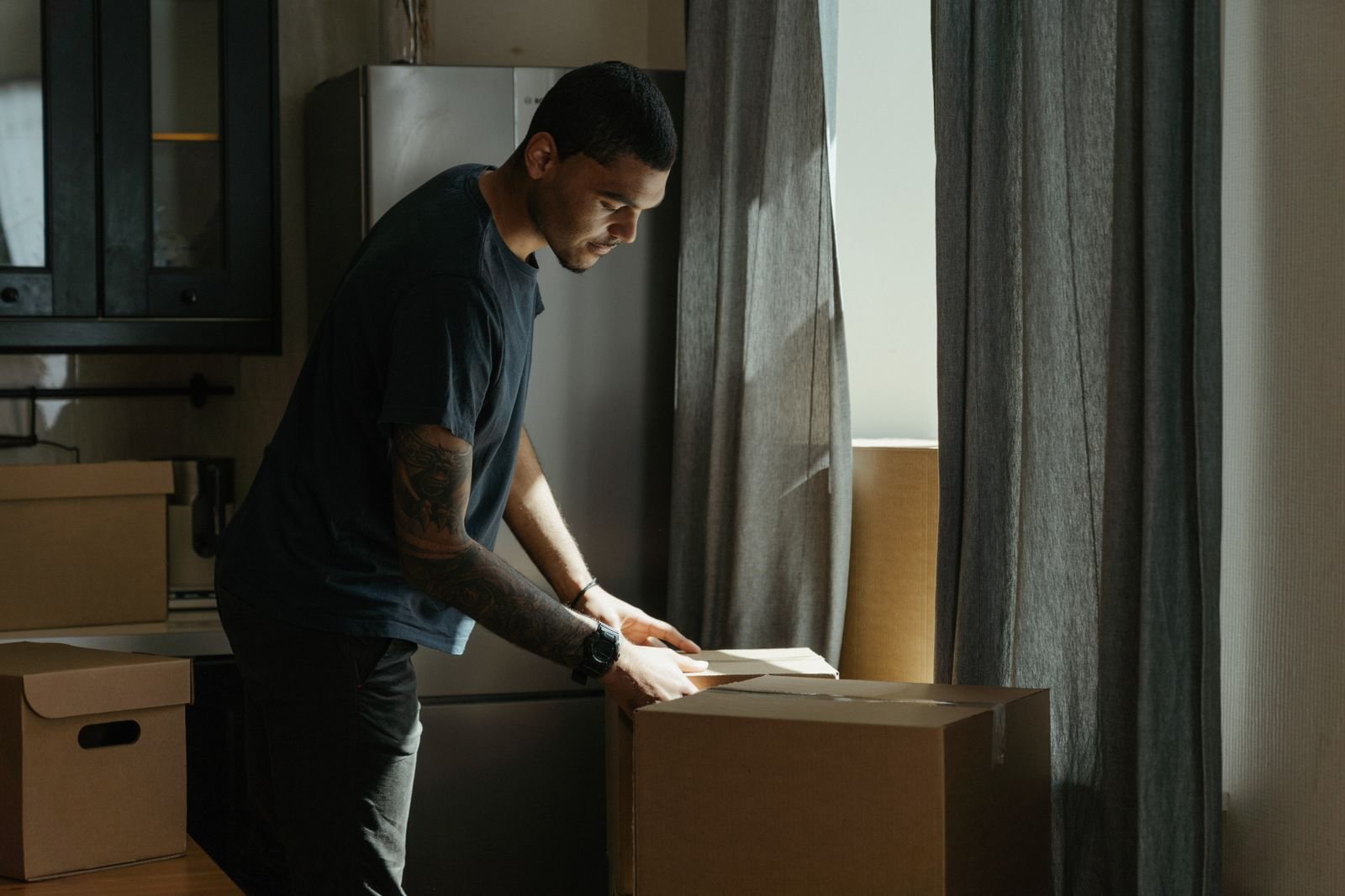 Team handling residential junk removal and sorting boxes in a modern Dubai apartment