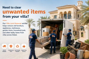 Crew carrying an old sofa out of a Dubai villa during a villa junk removal collection